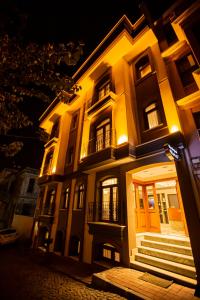 a lit up building with stairs in front of it at night at HaciBayramHotel in Istanbul