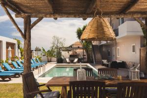 a patio with a table and chairs next to a pool at Bruma Luxury Residence in Mouzákion