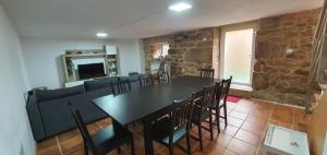 a dining room with a table and chairs and a couch at Casa Pinto - AL in Valença