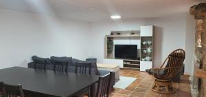 a living room with a black table and chairs at Casa Pinto - AL in Valença