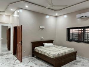 a bedroom with a bed and a mirror at Les Résidences de Gorée in Cotonou