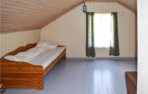 a bedroom with a bed in a room with a window at Awesome Home In Drangedal With Wifi And 3 Bedrooms in Drangedal