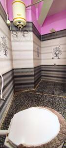 a bathroom with a white tub in a room with purple ceilings at Hotel Orchid in Kalimpong