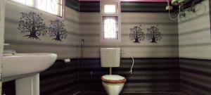 a bathroom with a sink and a toilet in it at Hotel Orchid in Kalimpong +35 photos