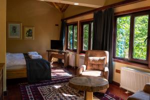 a bedroom with a bed and a chair and a table at The Canyon Kartepe and Restoran in Kartepe