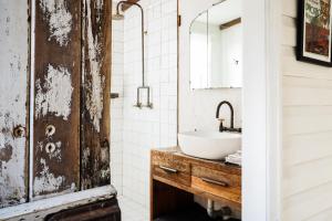 an old door in a bathroom with a sink at Mill Cottage in Tenterfield