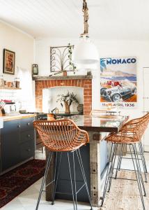 a kitchen with a brick fireplace and a table with chairs at Mill Cottage in Tenterfield
