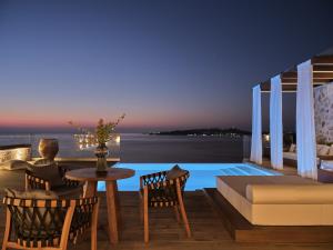 a villa with a view of the ocean at night at White Springs Retreat in Orthoniaí