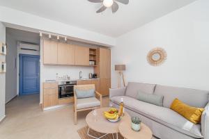 a living room with a couch and a table at Greek Beach House Complex B4 in Nydri