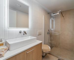 a bathroom with a white sink and a shower at Greek Beach House Complex B4 in Nydri