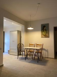 a dining room with a table and chairs at T&L Apartments Germasogia in Limassol