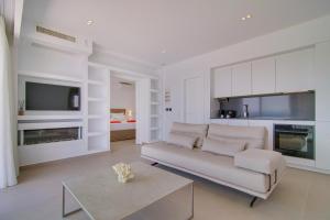 a living room with a couch and a table at LIVINGHOME SUITES in Parga