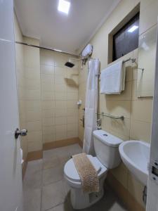 a bathroom with a toilet and a sink at Rooms R Us - Evangelista in Manila