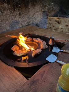 a grill with a bunch of food cooking in it at Le haut du temps in Sapois