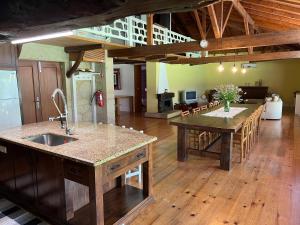 a large kitchen with a table and a dining room at O Celeiros in Freixo