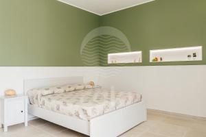 A bed or beds in a room at Villa Sabbia Bianca By Cala Salento