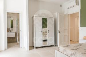 A bed or beds in a room at Villa Sabbia Bianca By Cala Salento