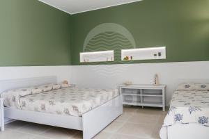 A bed or beds in a room at Villa Sabbia Bianca By Cala Salento