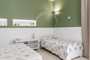 A bed or beds in a room at Villa Sabbia Bianca By Cala Salento