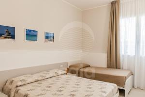 A bed or beds in a room at Villa Sabbia Bianca By Cala Salento