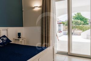 A bed or beds in a room at Villa Sabbia Bianca By Cala Salento