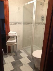 a bathroom with a shower and a toilet and towels at Executive Serviced Apartments 1 in Forfar