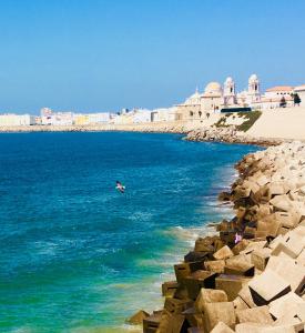 a person in the water near the beach at Ático Cádiz Suite in Cádiz