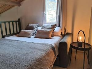 a bedroom with a bed with a window and a table at Le Clos des Vignes in Pauillac
