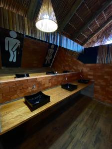 a bathroom with three sinks in a room at Pousada Cristal Dourado in Mateiros