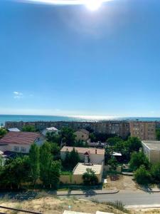 a view of a city with buildings and the ocean at 14-38 вид на море лучший район in Aktau
