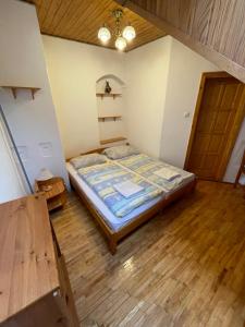 a bedroom with a bed and a desk at Katalinkert Panzió in Győr