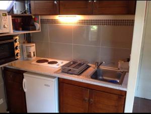 a kitchen with a sink and a counter top at Chalet lac de Payolle in Ancizan