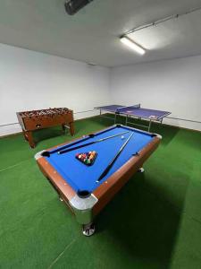 two ping pong tables in a room with green floors at Casa con piscina en el centro de Marbella. in Marbella