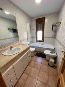 a bathroom with a sink and a tub and a toilet at Casa con piscina en el centro de Marbella. in Marbella