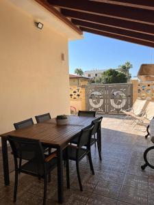 a wooden table and chairs on a patio at Casa BeFra Il relax che cercavi in Torre San Gennaro
