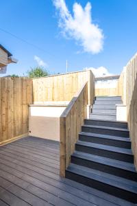 a set of stairs with a wooden fence at Newly renovated 2 bed house with large garden. in Phillack