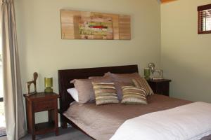 a bedroom with a bed with two night stands and two lamps at Scotsdale Valley Studios in Harewood