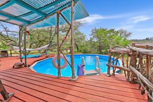 a wooden deck with a swimming pool on a house at Three Horses Ranch in Johnson City