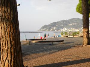 a bench on a beach with a view of the water at Appartamento SanBart Mare in San Bartolomeo al Mare