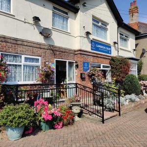 a house with flowers in front of it at Cameron court B&B in Flamborough