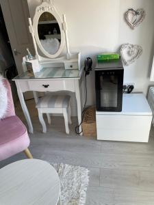 a dressing room with a desk and a mirror at Coastal Joy - Family and friends bedrooms in Newbiggin-by-the-Sea
