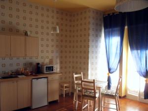 a kitchen with a table and chairs and a microwave at Leucosia Bed & Breakfast in Salerno