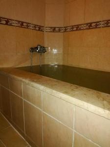 a bath tub with a faucet in a bathroom at Sagas Termal Butik Otel in Karahayit