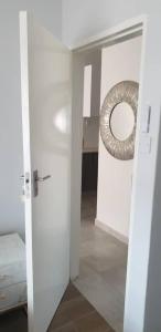 a room with a door with a mirror in it at Sarona city Habitat Alpha apartments C202 Gaborone in Gaborone