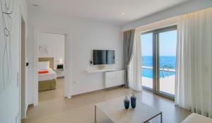 a hotel room with a bed and a view of the ocean at LIVINGHOME SUITES in Parga