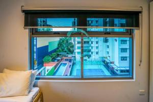 a bedroom window with a view of a swimming pool at ZEN AT ONE30: 3-BR Luxury Corporate Long Stays in Darwin