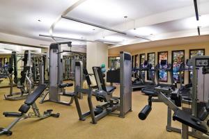 a gym with a bunch of treadmills and machines at Aspen St Regis Resort Hotel Room With 2 Queens in Aspen