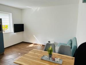 a living room with a couch and a table at Casa Caro in Prüm