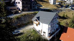 an aerial view of a white house on a hill at Casa Bunicutei in Ranca
