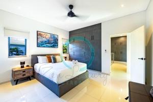 a bedroom with a large bed in a room at ZEN ARCTIC Luxury 2-Story T/House + Pool & Markets in Fannie Bay +50 photos